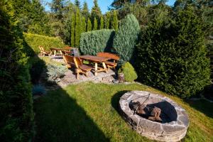 a backyard with a fire pit and a table and chairs at Willa pod Czantorią SPA Ustroń in Ustroń