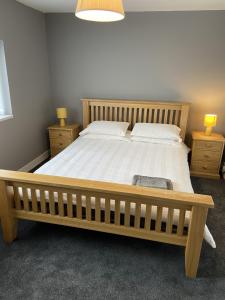 a bedroom with a large bed with two night stands at Sheffield spa view 2 bed house free parking in Sheffield