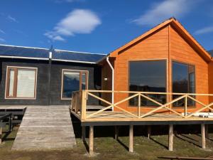 a house with a dock in front of it at Departamentos 8va Maravilla in Torres del Paine