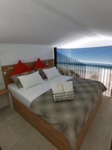 a bedroom with a bed with a view of the ocean at Alfa Studio in Kavala