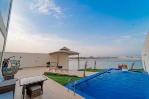 a swimming pool in a house with a view of the water at شاليه ايه in Half Moon Bay