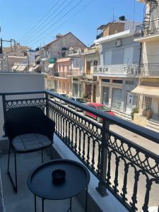 a balcony with a table and a chair on a balcony at Sogni D' Oro "Zen" in Zakynthos