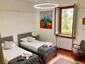 um quarto de hotel com duas camas e uma janela em Grove Cottage: Immersed in nature & close to town em Città della Pieve