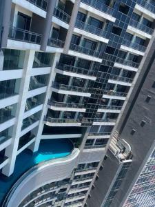 an aerial view of a large building with a swimming pool at 1 Bedroom Flat in Gramercy Residences Condo in Manila