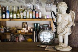 a statue of a girl standing on a shelf with a glass jar at Soesauna Farmstay in Vetla