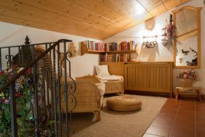 uma sala de estar com um sofá, uma cadeira e livros em Landhaus Doris em Leutasch