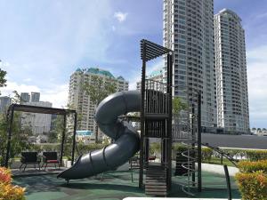 a playground with a slide in a city at LM HomeyA 3 BdRm Coastline View condo for 4-14 Pax with Netflix & Coway Water Purifier in Tanjong Tokong