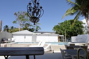 a view of a pool with chairs and a chandelier at Viento Beach Lodge in Dorado