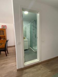 a mirror in a room with a bathroom at Suites Setúbal - River View in Setúbal +8 photos