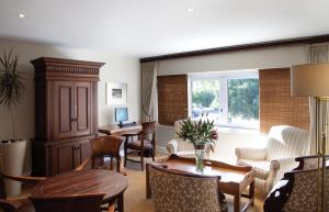 a living room with a table and chairs at Cape Town Hollow Boutique Hotel in Cape Town