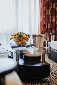 un tavolo con un cesto di frutta e bicchieri da vino di Hotel Lion a Ulcinj
