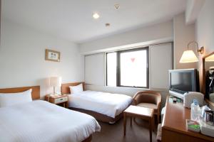 Rúm í herbergi á Smile Hotel Sugamo