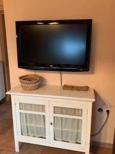 a flat screen tv on top of a white cabinet at ZeusPlace Olympus Olive Country House 2 in Leptokarya