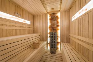 a sauna with wooden paneling and a wooden floor at SIGNUM Hotel in Podgorica