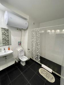 a bathroom with a shower and a toilet and a sink at East Residence in Kyiv +96 photos
