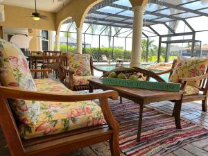 a lobby with chairs and a table with a bowl of fruit at Villagoona in Cape Coral