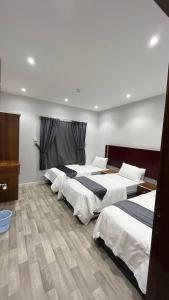 a group of four beds in a room at دانة تاون للوحدات السكنية "يوجد إيجار شهري" in Abha +7 photos