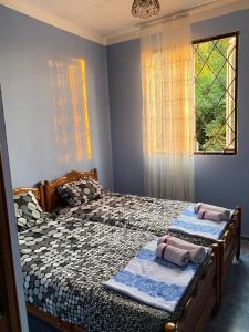 a bedroom with two beds with towels on them at Holiday Home in Gonio in Gonio