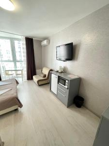 a hotel room with a television on the wall at East Residence in Kyiv