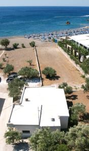 an aerial view of a beach with a white trailer at Kind of Blue Studios in Koutsounari