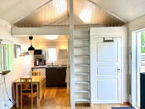 a tiny house with a staircase leading to a kitchen at Bittes & Lasses Guest House in Kalmar