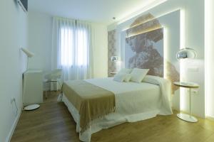 - une chambre avec un lit orné d'une peinture murale dans l'établissement Enlakruz, à Lagartera