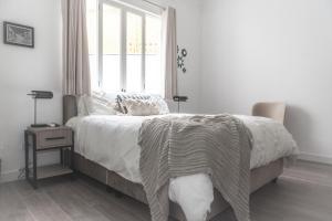 a bedroom with a large bed with a window at WasiPai Boutique Hotel in Lima