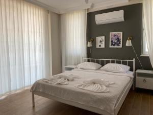 a bedroom with a bed with two towels on it at Villa Sunrise in Dalyan