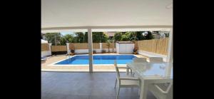 a patio with a table and chairs and a swimming pool at Villa Sunrise in Dalyan