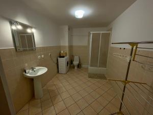 a bathroom with a sink and a toilet at Apartamenty nad jeziorem - 4 in Ełk