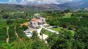 an aerial view of a white house with trees at Villa Florentina ✩ Private Pool ✩ BBQ ✩ 7 Guests in Alikianós