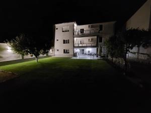 a large building with a yard at night at Premium Central Apartment in Oradea +16 photos