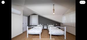 a room with three white beds and a staircase at Villa Sunset in Dalyan +17 photos