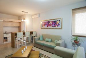 a living room with a couch and a table at Apartments Villa Splendor in Vrnjačka Banja