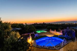 an image of a backyard with a swimming pool at sunset at Stone House Irene in Hersonissos