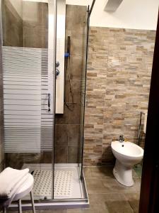 a bathroom with a shower and a sink at Alla Posta Guest House in Garna dʼAlpago +52 photos