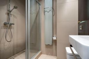 a bathroom with a shower and a toilet and a sink at Lux modern apartment in Krakow