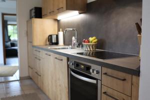 a kitchen with a sink and a stove at Ferienwohnung Mariedei in Berchtesgaden