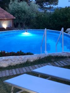 a swimming pool at night with blue water at Villa Messerà in Martina Franca