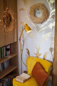 a lamp and a yellow chair in a room at The Queen Bee Cabin in Hereford