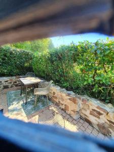 a table and chairs sitting on a brick patio at Four à pain in Torcé-en-Charnie