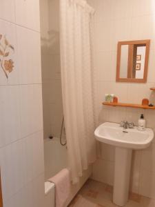 a white bathroom with a sink and a shower at Villas Del Mar 2-bedroom Apartment with Swimming pool in Torrevieja