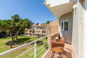 a balcony with a wooden bench on a building at Casa Faria da Costa in Esposende