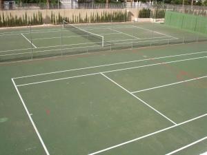 a tennis court with two tennis courts at Gemelos 22 - Zand Properties in Benidorm