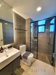 a bathroom with a toilet and a sink and a shower at Brojat Suite Family City View @ Imperium Residence in Kuantan