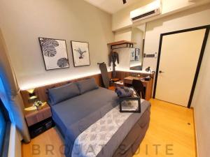 a small bedroom with a bed and a desk at Brojat Suite Family City View @ Imperium Residence in Kuantan +45 photos