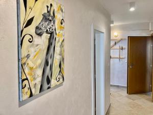 a painting of a giraffe hanging on a wall at Orfey Apartment in Sofia