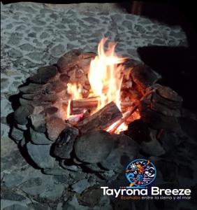 a fire is burning in a stone oven at tayrona breeze in Santa Marta