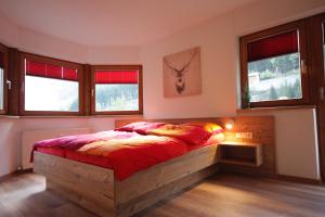 a bedroom with a bed in a room with windows at Hirschstube in Ischgl