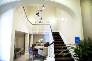 a staircase with a dining room and a table and chairs at Shore View Hotel in Eastbourne